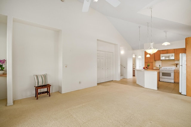 unfurnished living room with light colored carpet, high vaulted ceiling, and a ceiling fan