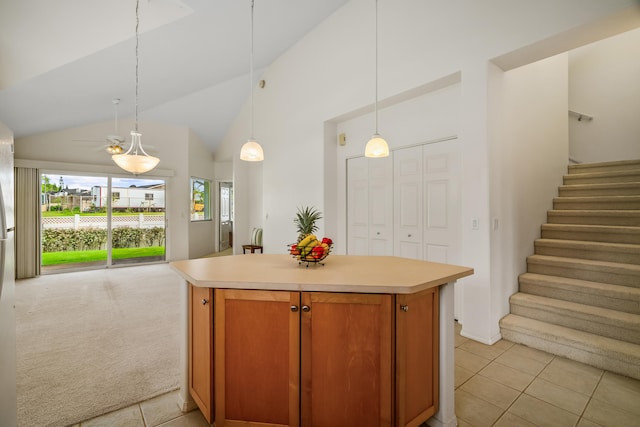 kitchen with open floor plan, vaulted ceiling, light countertops, a kitchen island, and light tile patterned floors