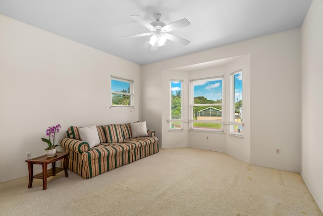 sitting room with carpet flooring, healthy amount of natural light, and a ceiling fan