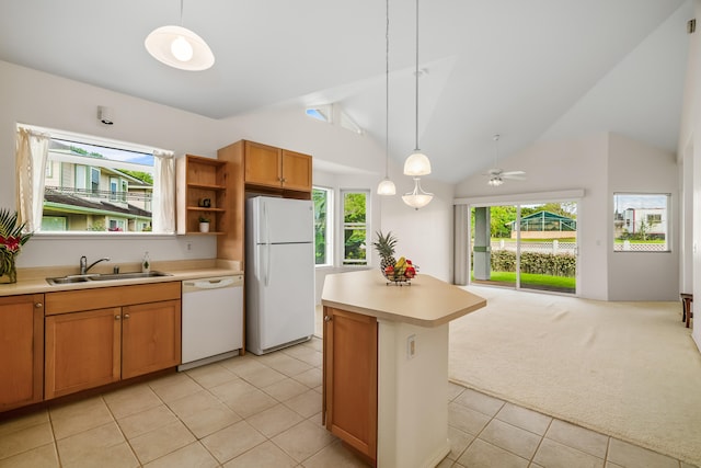 kitchen featuring white appliances, a sink, open floor plan, light countertops, and lofted ceiling