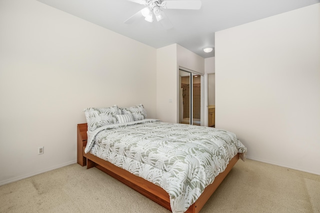bedroom with carpet flooring, baseboards, ceiling fan, and a closet
