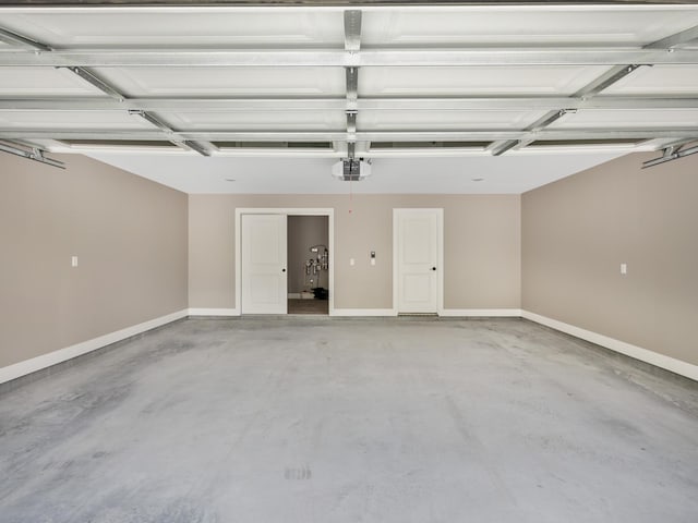 garage with a garage door opener and baseboards