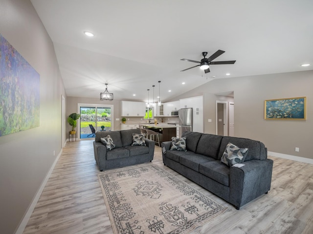 living room with vaulted ceiling, light wood finished floors, recessed lighting, baseboards, and ceiling fan