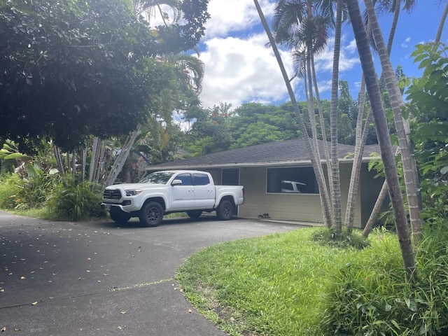 view of home's exterior with a shingled roof