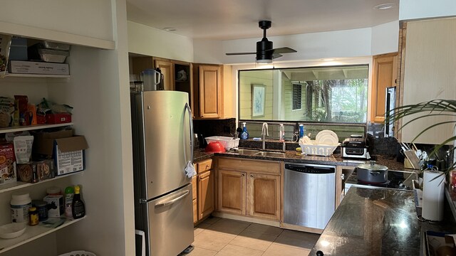 kitchen with stainless steel appliances, a sink, ceiling fan, light tile patterned floors, and brown cabinetry