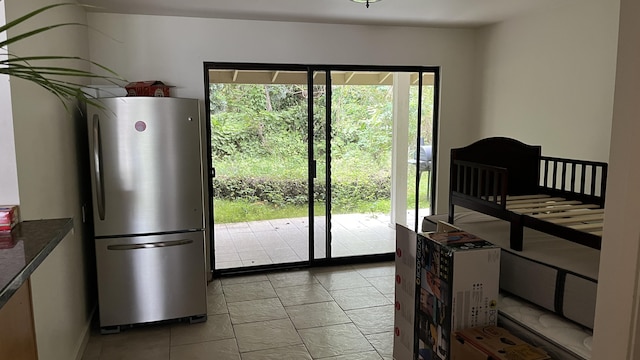doorway to outside with light tile patterned flooring