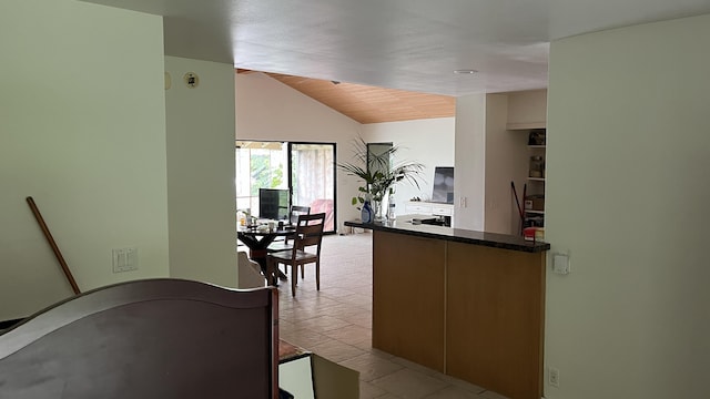 kitchen featuring dark countertops and lofted ceiling