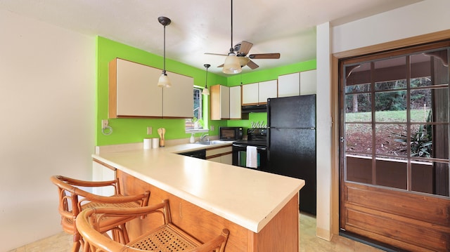3411 Wilcox Rd Unit Fii65, Lihue, HI 96766 - kitchen with black appliances, a ceiling fan, light countertops, and under cabinet range hood