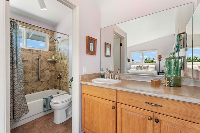 ensuite bathroom with healthy amount of natural light, toilet, vanity, and shower / bathtub combination with curtain