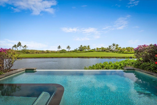 view of swimming pool with a yard and a water view
