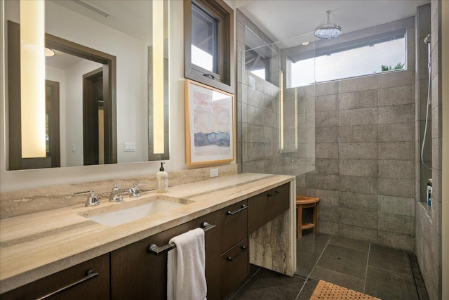 full bath with walk in shower, tile patterned floors, and vanity
