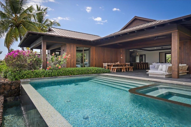 outdoor pool featuring an in ground hot tub