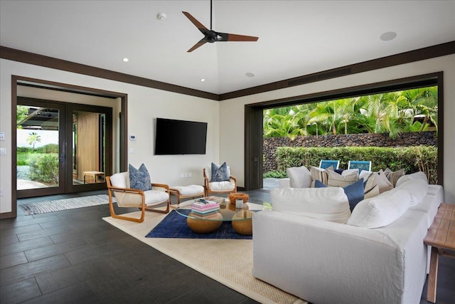 living room with lofted ceiling, a wealth of natural light, visible vents, and ceiling fan