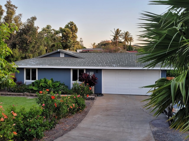 single story home with a garage, concrete driveway, stucco siding, and a tiled roof
