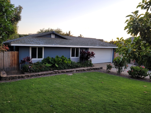 ranch-style home with an attached garage, stucco siding, and concrete driveway
