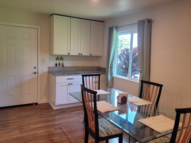 dining room featuring dark wood-style flooring