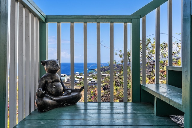 sunroom featuring a water view