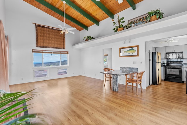 dining area with ceiling fan, wood ceiling, beamed ceiling, light wood-style floors, and high vaulted ceiling
