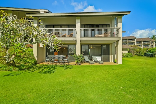 5380 Honoiki Rd Unit F16, Princeville, HI 96722 - back of house with a balcony, stucco siding, a lawn, and a patio area