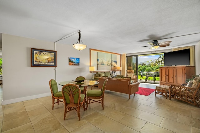 5380 Honoiki Rd Unit F16, Princeville, HI 96722 - dining area featuring ceiling fan, baseboards, light tile patterned floors, and expansive windows