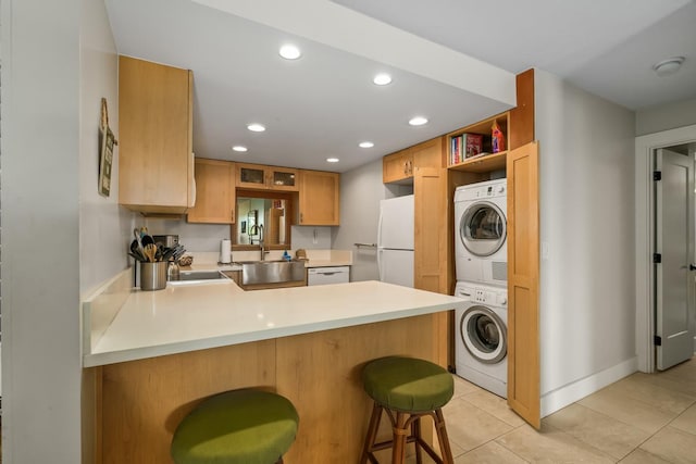 5380 Honoiki Rd Unit F16, Princeville, HI 96722 - kitchen with stacked washer / dryer, white appliances, a peninsula, recessed lighting, and light countertops