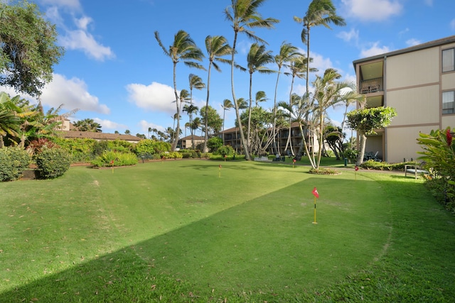 view of property's community with a putting area and golf course view
