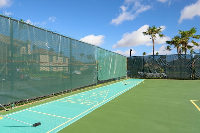 surrounding community with shuffleboard and fence