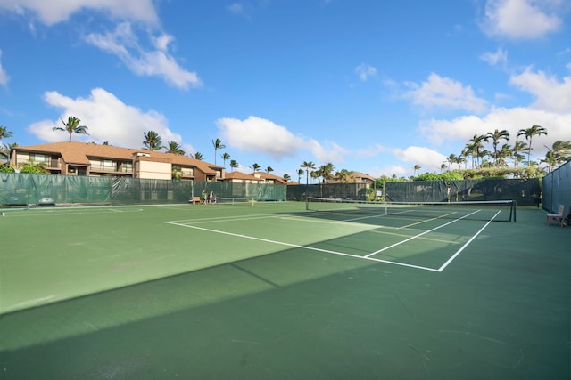 view of tennis court with fence