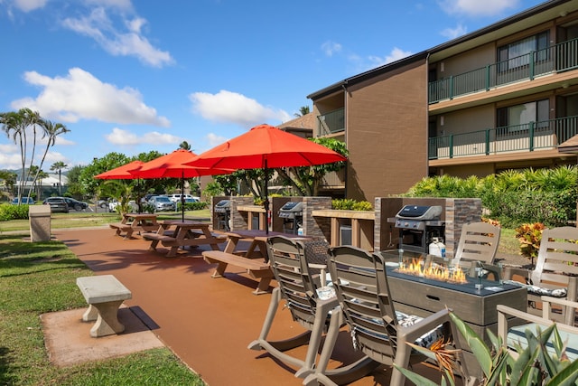view of property's community featuring an outdoor fire pit