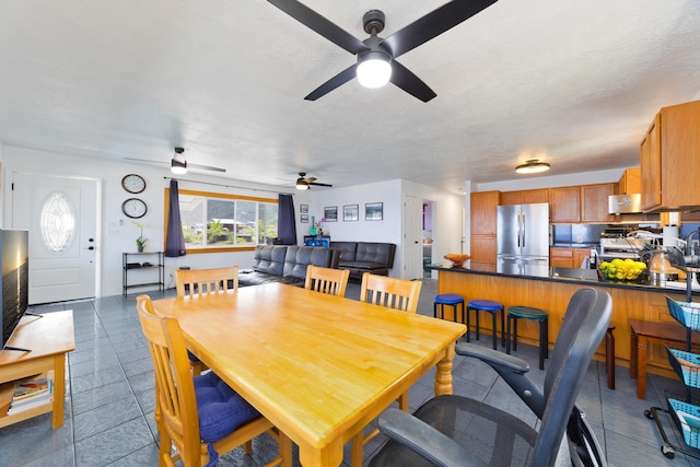 dining space featuring a ceiling fan and plenty of natural light