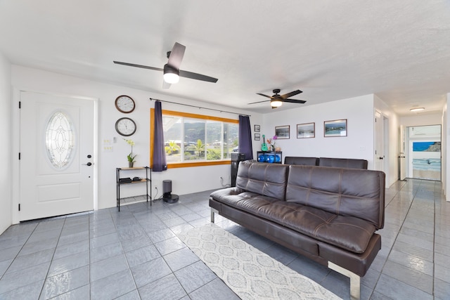 tiled living area featuring a ceiling fan