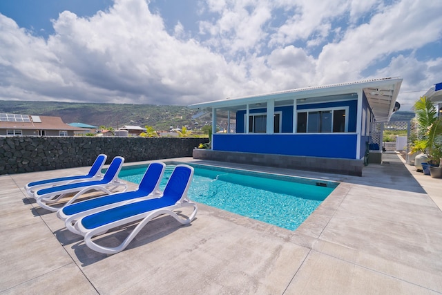 view of pool with a patio area and fence