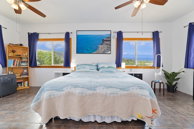 bedroom with ceiling fan and tile patterned floors