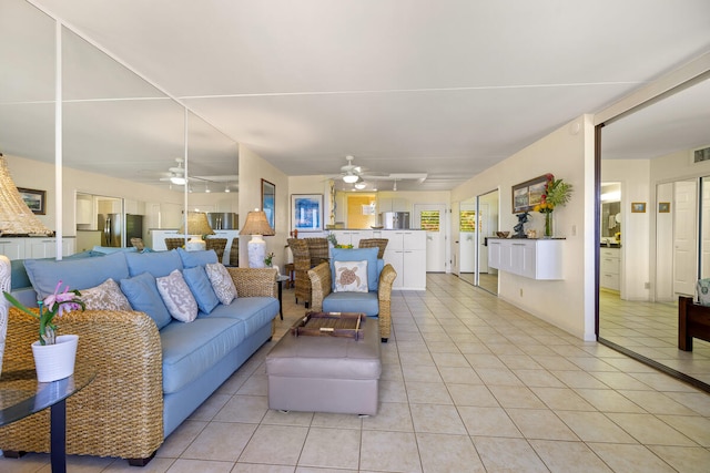 living room with light tile patterned floors and a ceiling fan
