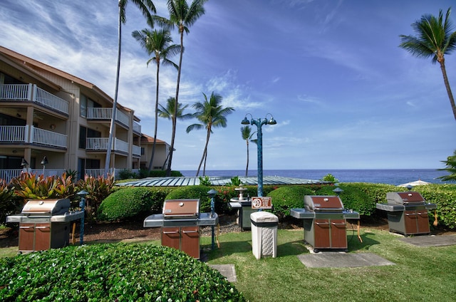 view of property's community featuring a water view and a yard