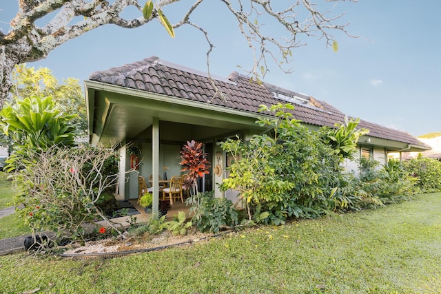 3880 Wyllie Rd Unit 5A, Princeville, HI 96722 - view of side of home with a yard and a tile roof