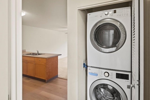 3920 Haoa St Unit 322, Lihue, HI 96766 - laundry room featuring stacked washer / drying machine and light wood-type flooring