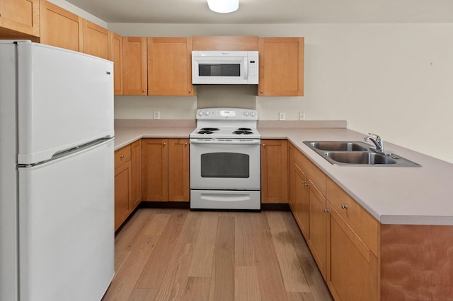 3920 Haoa St Unit 322, Lihue, HI 96766 - kitchen featuring white appliances, a sink, light wood finished floors, light countertops, and a peninsula