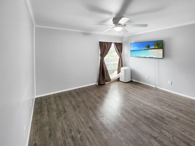 empty room featuring ceiling fan, wood finished floors, crown molding, and baseboards