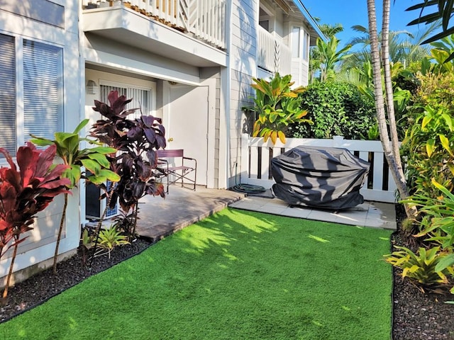 view of yard featuring a patio and a balcony