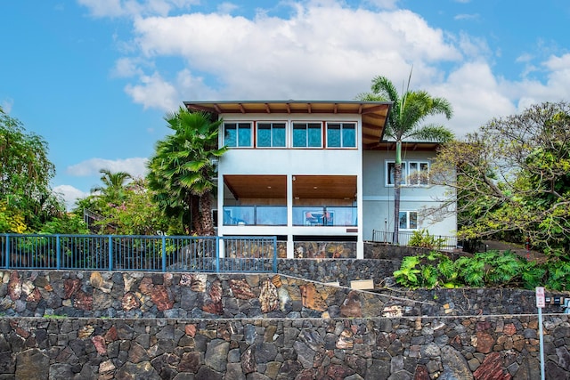 rear view of house with fence