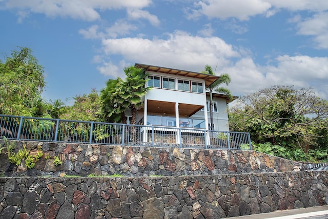 rear view of house featuring fence