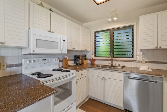 4460 Nehe Rd Unit 122, Lihue, HI 96766 - kitchen featuring white appliances, a sink, decorative backsplash, and dark stone countertops
