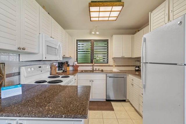 4460 Nehe Rd Unit 122, Lihue, HI 96766 - kitchen featuring white appliances, a sink, decorative backsplash, light tile patterned floors, and white cabinetry