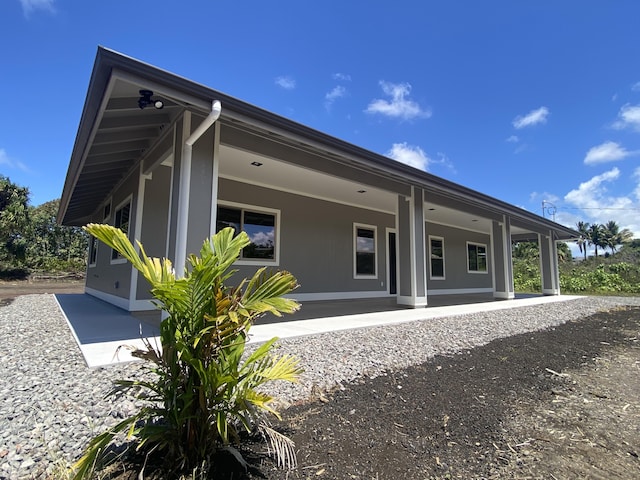 back of property with a porch