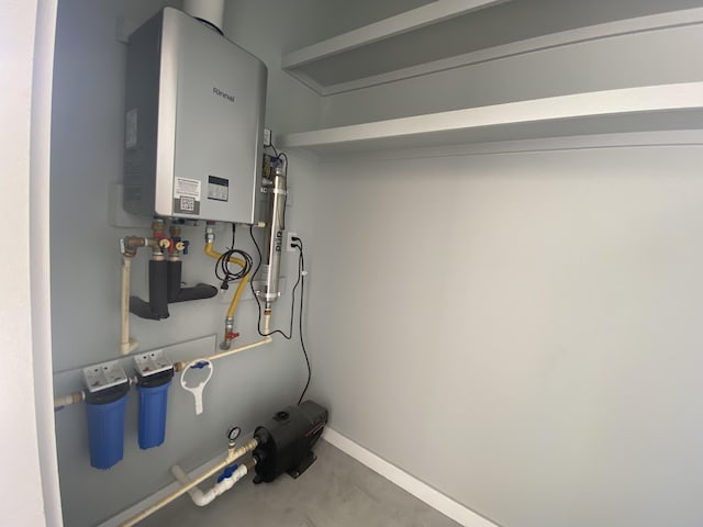 utility room featuring tankless water heater