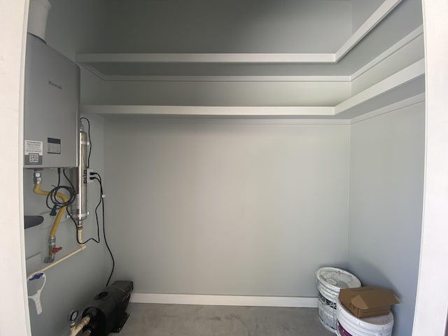 spacious closet featuring tankless water heater