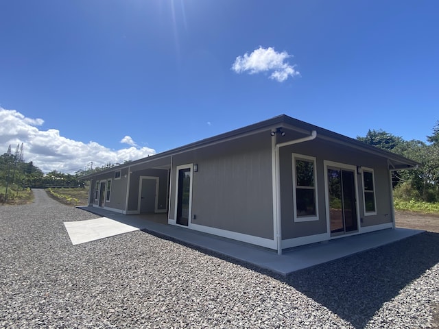view of property exterior with a patio