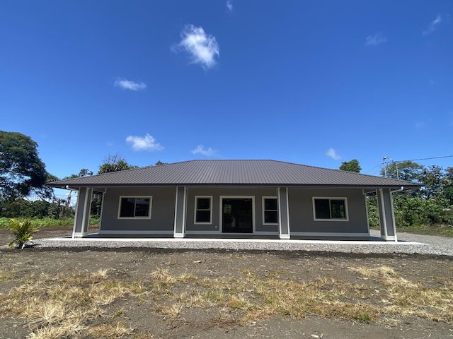 view of front of home featuring a porch and metal roof