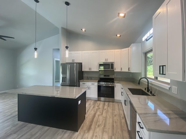 kitchen featuring stainless steel appliances, a sink, high vaulted ceiling, light stone counters, and a kitchen island